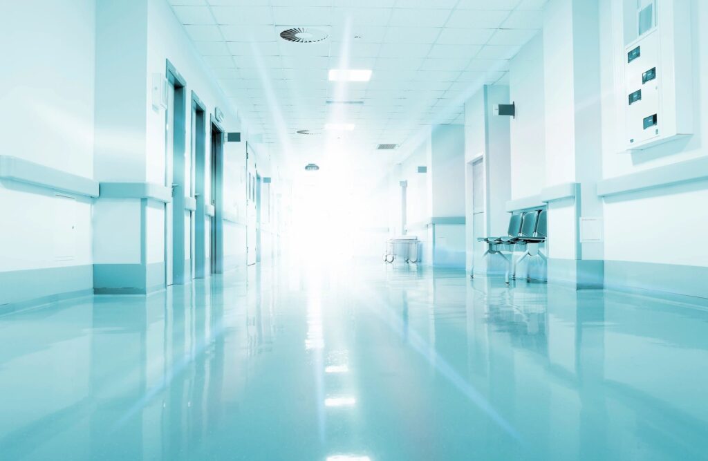 A hospital hallway with very bright light at the end